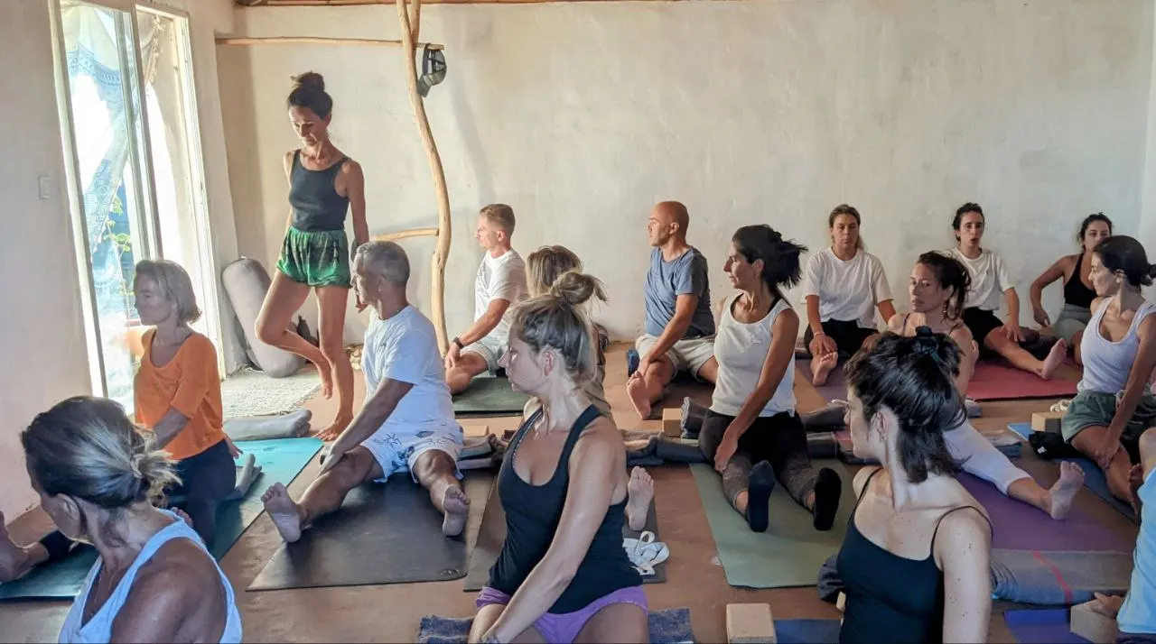 A yoga class in the clay-floored yoga room at Malama